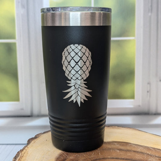 Stainless steel tumbler laser-etched with an upside-down pineapple design. Insulated swinger drinkware for lifestyle parties and subtle expression.