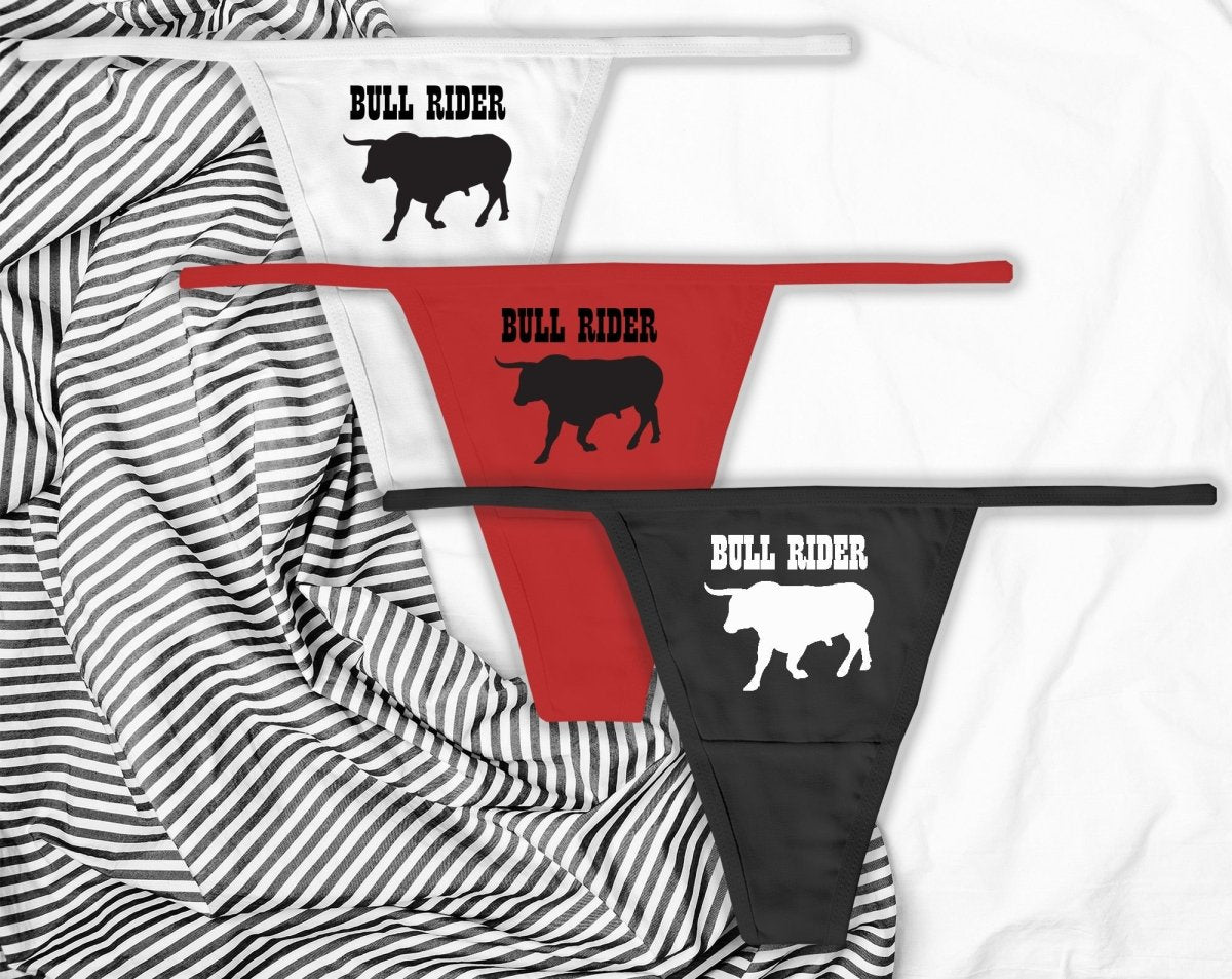 Sexy black thongs with “Bull Rider” text. Western-inspired lingerie for confident women who love to ride hard and dominate the scene.