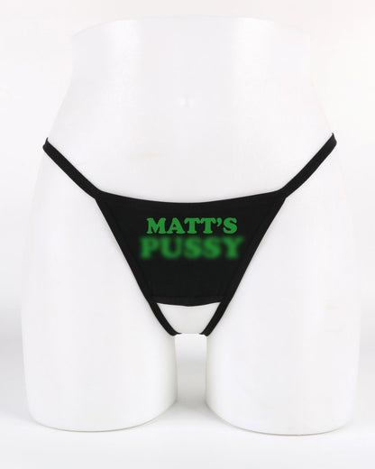 Black thong with 'MATT'S PUSSY' printed in green on a white background