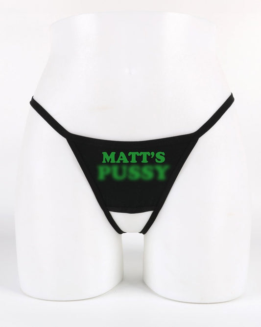 Black thong with 'MATT'S PUSSY' printed in green on a white background