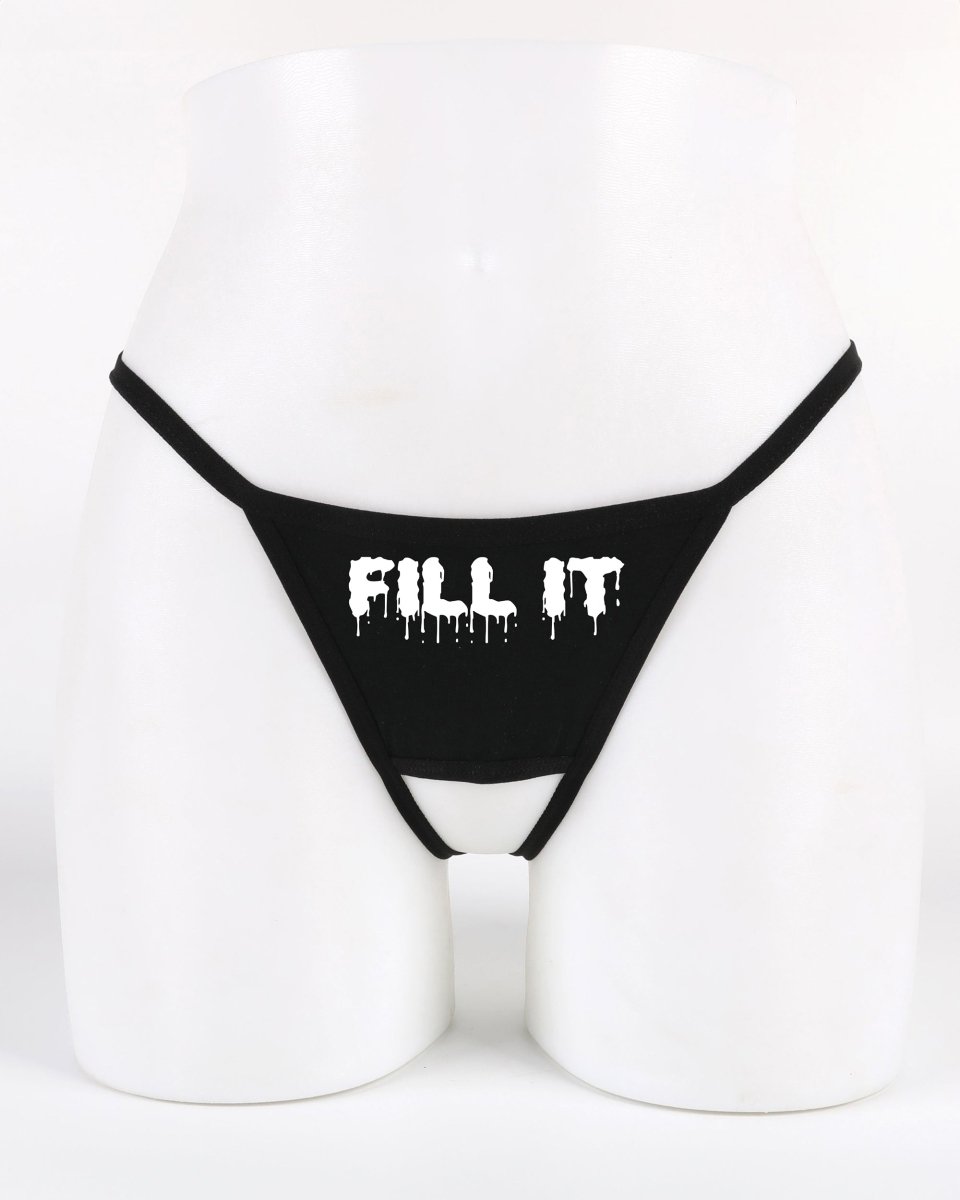 Black crotchless thong with bold “Fill It” text across the front — provocative lifestyle lingerie from Wicked Boutique®