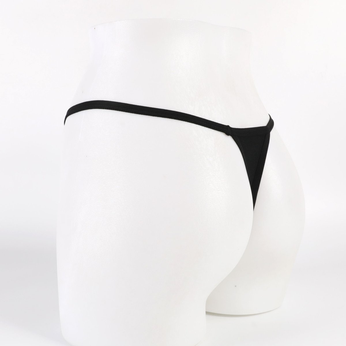 Black thong on a white mannequin against a white background