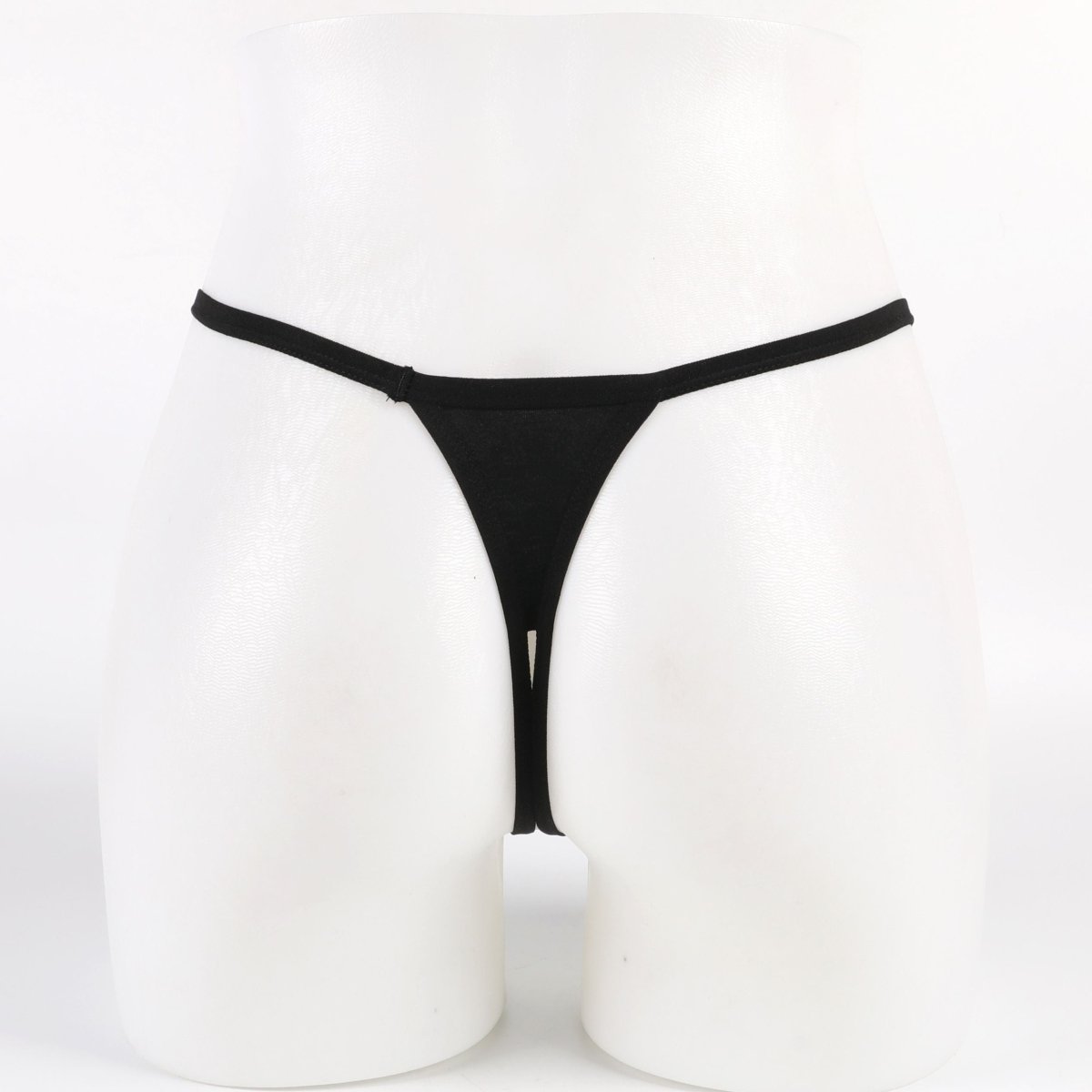 Black thong on a white mannequin against a white background