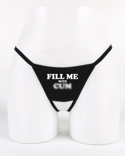 Black crotchless thong with “Fill Me With Cum” text across the front — provocative underwear for hotwife and swinger fun from Wicked Boutique®
