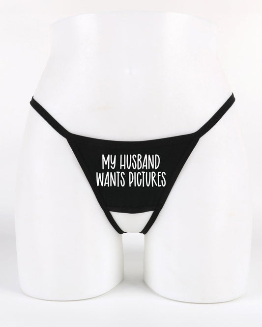 Black thong with 'My Husband Wants Pictures' text on a white background