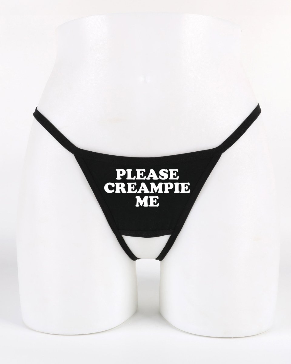 Black crotchless thong panty with bold white “Please Creampie Me” text — explicit and provocative lingerie from Wicked Boutique®
