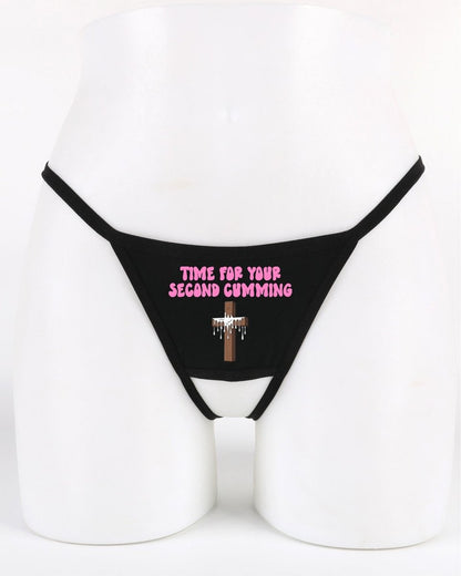 Black thong with pink text on a mannequin against a white background