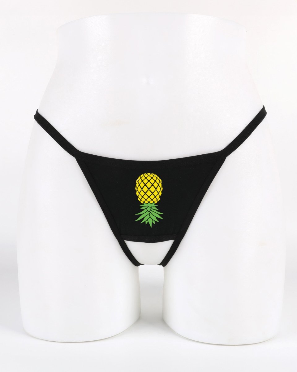 Black crotchless thong with upside-down pineapple graphic—lifestyle lingerie that signals subtle swinger interest.